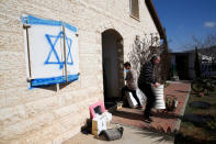 A member of the Ben Shushan family (R) carries objects out of his home as they expect an eviction in the Israeli settlement of Ofra, in the occupied West Bank February 6, 2017. REUTERS/Baz Ratner