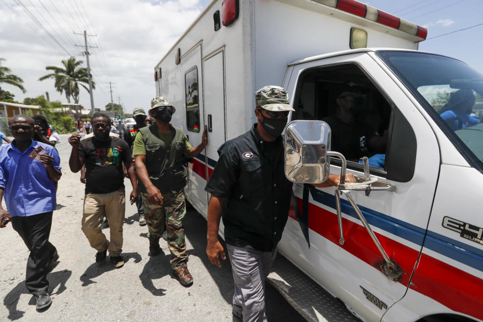 An ambulance carrying former Haitian President Jean-Bertrand Aristide leaves the airport after his arrival from Cuba, where he underwent medical treatment, in Port-au-Prince, Haiti, Friday, July 16, 2021. President Jovenel Moise was assassinated at his home on July 7. (AP Photo/Fernando Llano)
