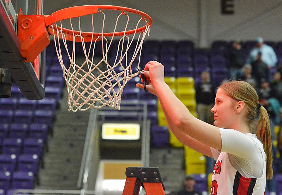 Freshman Saylor Langager takes her turn at cutting down the net after Sisseton's 63-52 win over Tri-Valley in a Class A SoDak 16 girls basketball game on Thursday, Feb. 29, 2024 in the Watertown Civic Arena.