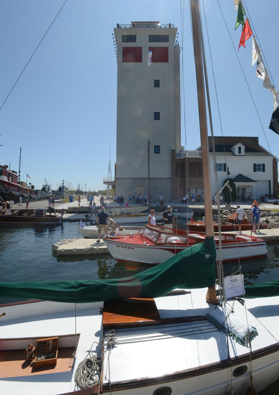 Boats at the Door County Maritime Museum's Classic and Wooden Boat Show are on display not just on the museum grounds but in the channel bordering the grounds. Seen here are some of those boats backed by the museum's new10-story Jim Kress Maritime Lighthouse Tower at the 2021 show.