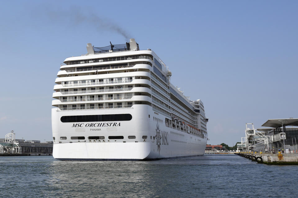 The the 92,409-ton, 16-deck MSC Orchestra cruise ship exits the lagoon as it leaves Venice, Italy, Saturday, June 5, 2021. The first cruise ship leaving Venice since the pandemic is set to depart Saturday amid protests by activists demanding that the enormous ships be permanently rerouted out the fragile lagoon, especially Giudecca Canal through the city's historic center, due to environmental and safety risks. (AP Photo/Antonio Calanni)