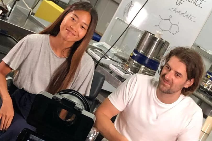 woman and man sat next to each other in front of camera