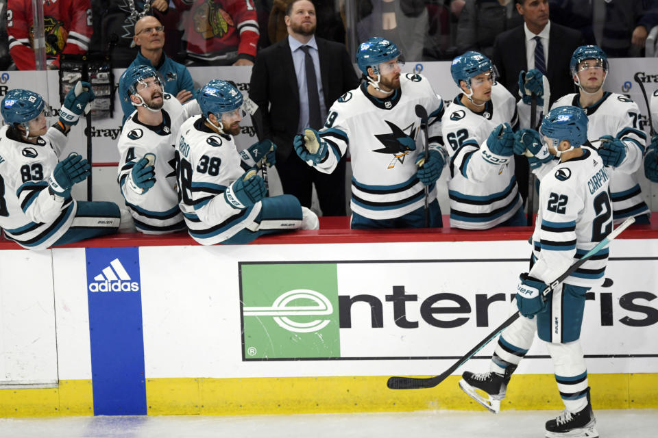 San Jose Sharks' Ryan Carpenter (22) celebrates with teammates at the bench after scoring a goal during the third period of an NHL hockey game against the Chicago Blackhawks Tuesday, Jan 16, 2024, in Chicago. (AP Photo/Paul Beaty)