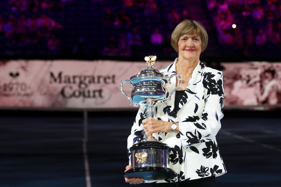 Margaret Court, pictured here with a replica Daphne Akhurst trophy on Rod Laver Arena at the Australian Open in 2020.