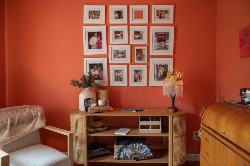 Before the “Swedish Death Cleaning” crew came through, framed photos covered nearly every inch of wall in this room in Suzi Sanderson’s home. Now most of the photos are tucked into a basket, and Sanderson plans to send some to the people in the photos.