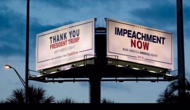 Competing opinions come into view while driving past billboards at the intersection of I-95 and Southern Boulevard in West Palm Beach. The billboards are along the motorcade route the president travels from Palm Beach International Airport to Mar-a-Lago. April 16, 2020.