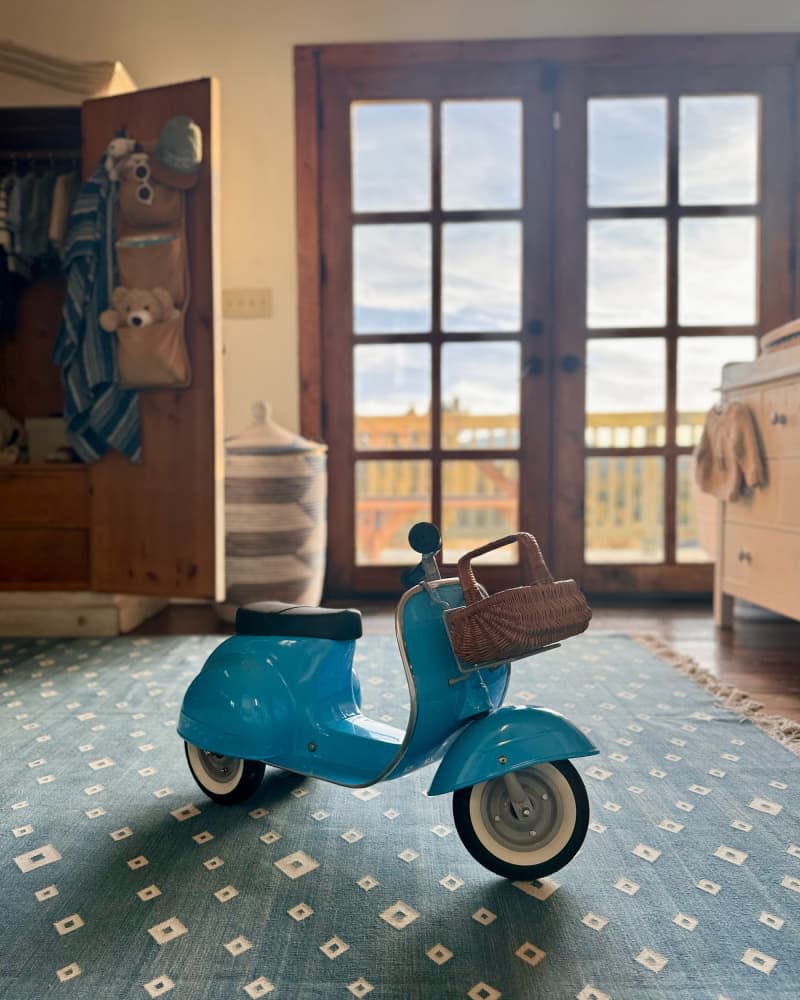 Baby bike on floor of newly designed nursery.