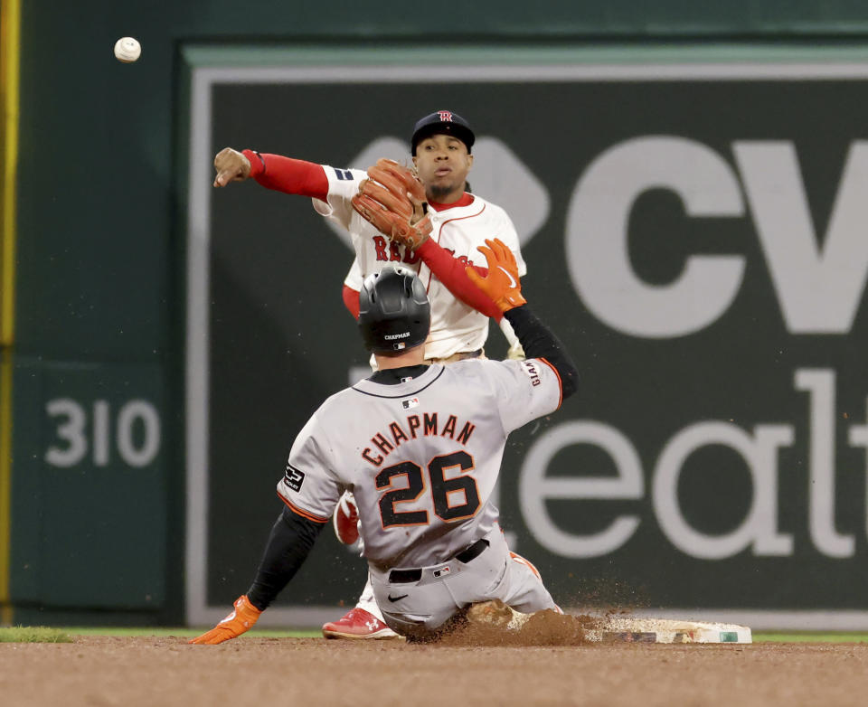 Boston Red Sox second baseman Enmanuel Valdez tags out San Francisco Giants' Matt Chapman (26) for the first out of a double play throwing to first during the ninth inning of a baseball game against the San Francisco Giants, Wednesday, May 1, 2024, in Boston. (AP Photo/Mark Stockwell)