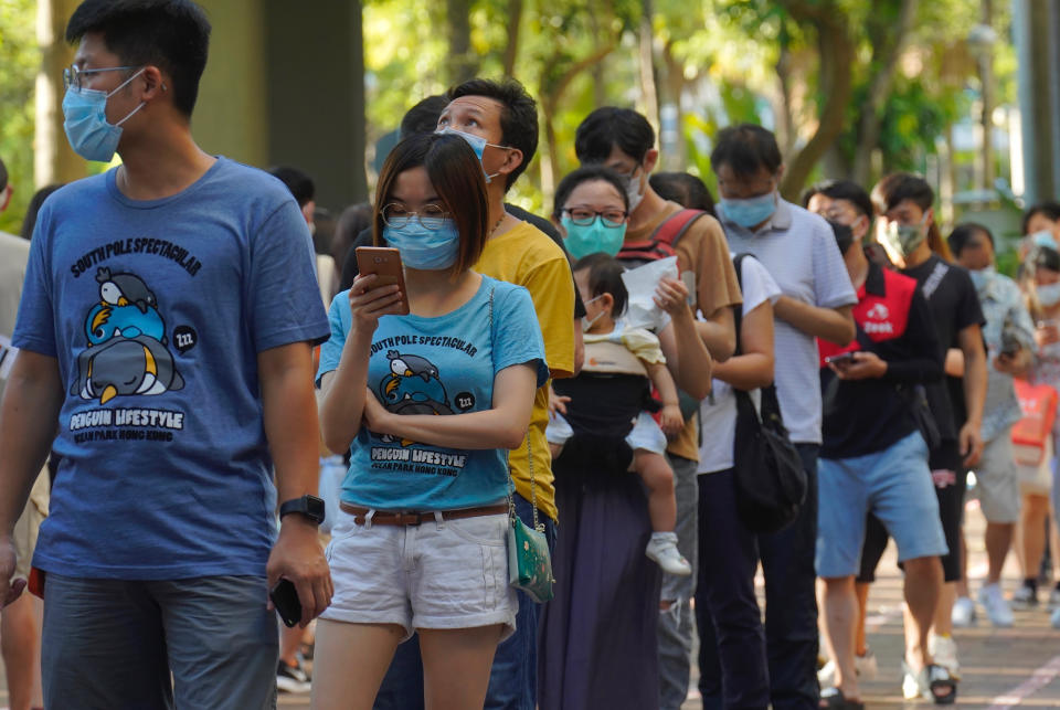 People queue up to vote in Hong Kong Sunday, July 12, 2020, in an unofficial primary for pro-democracy candidates ahead of legislative elections in September. Over 200,000 Hong Kongers voted in an unofficial Hong Kong primary that will help the pro-democracy camp decide which candidates to field in legislative elections in September. The turnout exceeded organizers' estimates that some 170,000 people would turn up to vote over the weekend. (AP Photo/Vincent Yu)