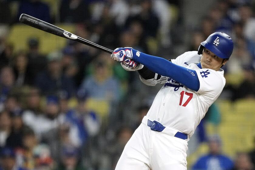 Los Angeles Dodgers' Shohei Ohtani hits a solo home run during the first inning.