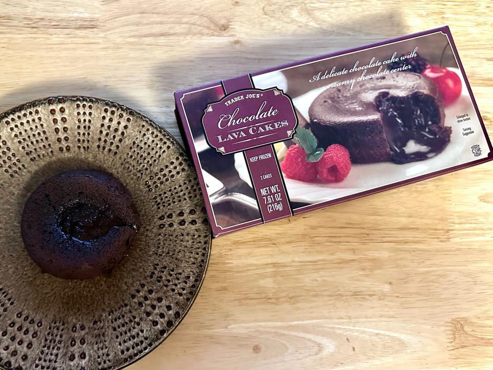 Trader Joe's chocolate lava cake on a plate next to box on a counter