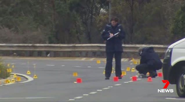 Police search the crime scene at the Western Ring Road. Picture: 7 News