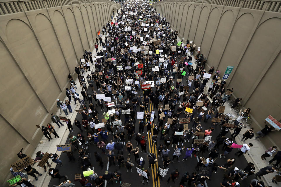 Protesters march Thursday, June 4, 2020, in San Diego. Protests continue in U.S. cities, sparked by the death of George Floyd, a black man who died after being restrained by Minneapolis police officers on May 25. (AP Photo/Gregory Bull)