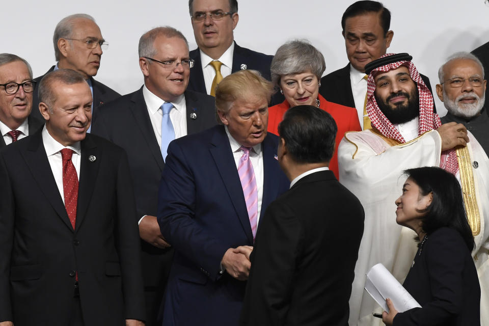 President Donald Trump, center, shakes hands with Chinese President Xi Jinping, as they gather for a group photo at the G-20 summit in Osaka, Japan, Friday, June 28, 2019. (AP Photo/Susan Walsh)