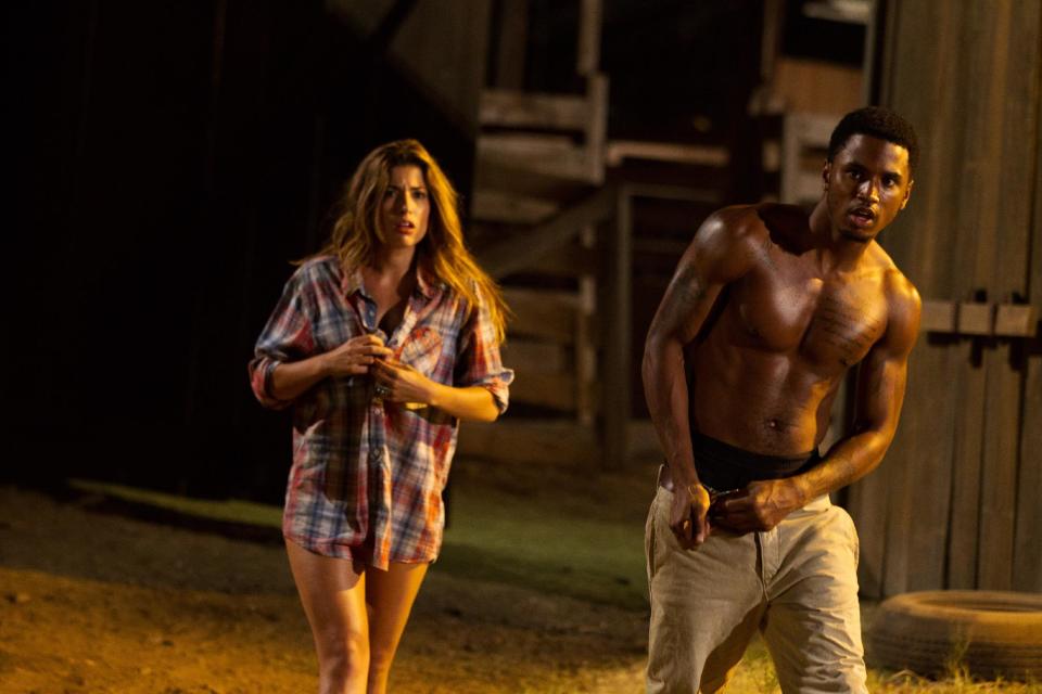 This undated publicity film image from Lionsgate shows Tania Raymondei, left, as Nikki, and Tremaine "Trey Songz" Neverson, as Ryan, in a scene from "Texas Chainsaw 3-D," releasing in theaters on Friday, January 4, 2013. (AP Photo/Lionsgate, Justin Lubin)