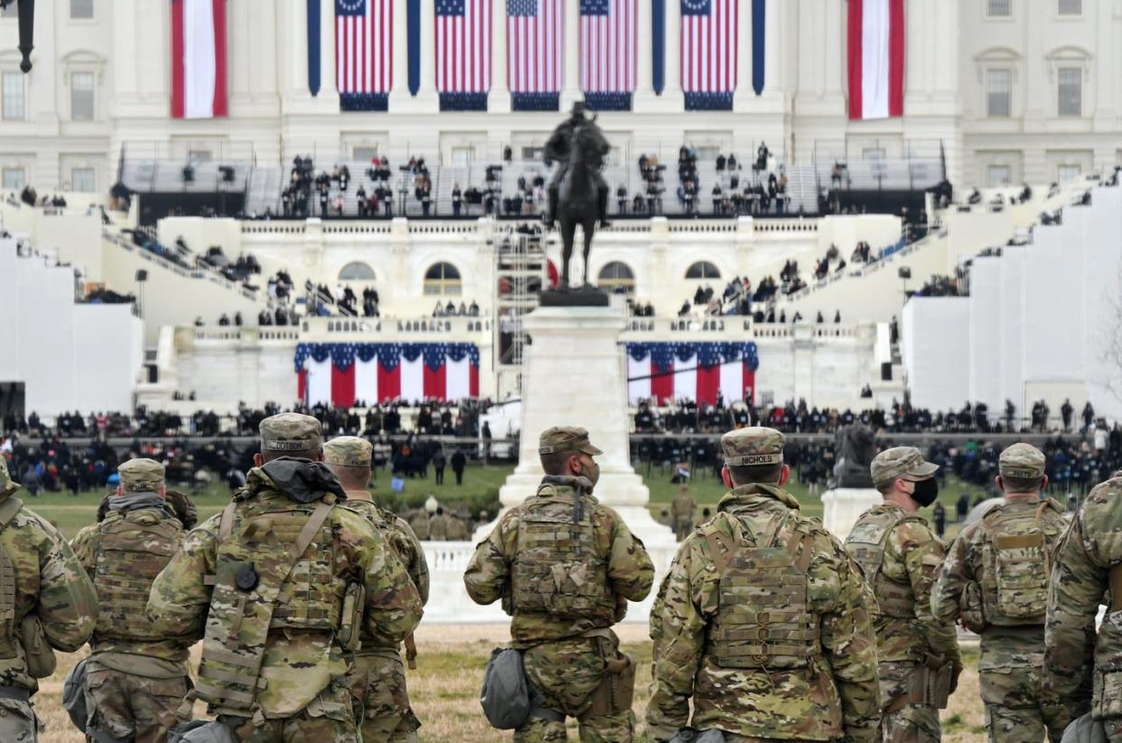 <span class="caption">Some 25,000 National Guard troops protected Joe Biden's presidential inauguration due to fears of a far-right extremist attack.</span> <span class="attribution"><a class="link " href="https://www.gettyimages.com/detail/news-photo/members-of-the-national-guard-gather-near-the-u-s-capitol-news-photo/1297445025?adppopup=true" rel="nofollow noopener" target="_blank" data-ylk="slk:Stephanie Keith/Getty Images;elm:context_link;itc:0;sec:content-canvas">Stephanie Keith/Getty Images</a></span>