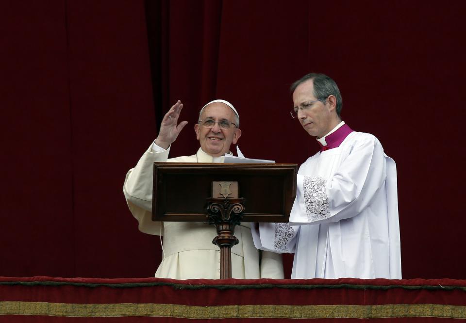 Pope Francis waves as he delivers his first "Urbi et Orbi" message from the balcony overlooking St. Peter's Square at the Vatican