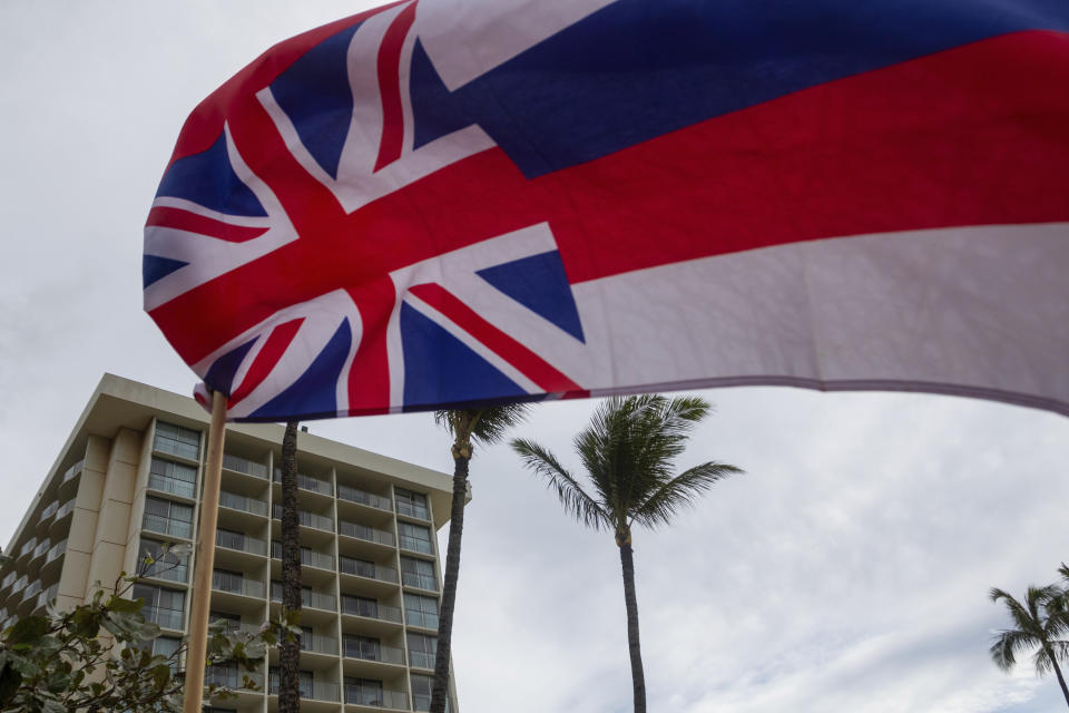 The state of Hawaii flag hung upside down outside of a beach side resort on Friday, Dec. 1, 2023, in Lahaina, Hawaii. Lahaina Strong has set up a "Fish-in" to protest living accommodations for those displaced by the Aug. 8, 2023 wildfire, the deadliest U.S. wildfire in more than a century. More than four months after the fire, tensions are growing between those who want to welcome tourists back to provide jobs and those who feel the town isn't ready for a return to tourism." (AP Photo/Ty O'Neil)