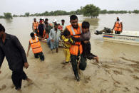 FILE - Army troops evacuate people from a flood-hit area in Rajanpur, district of Punjab, Pakistan, Aug. 27, 2022. Loss and damage is the human side of a contentious issue that will likely dominate climate negotiations in Egypt. Extreme weather is worsening as the world warms, with a study calculating that human-caused climate change increased Pakistan’s flood-causing rain by up to 50%. (AP Photo/Asim Tanveer, File)