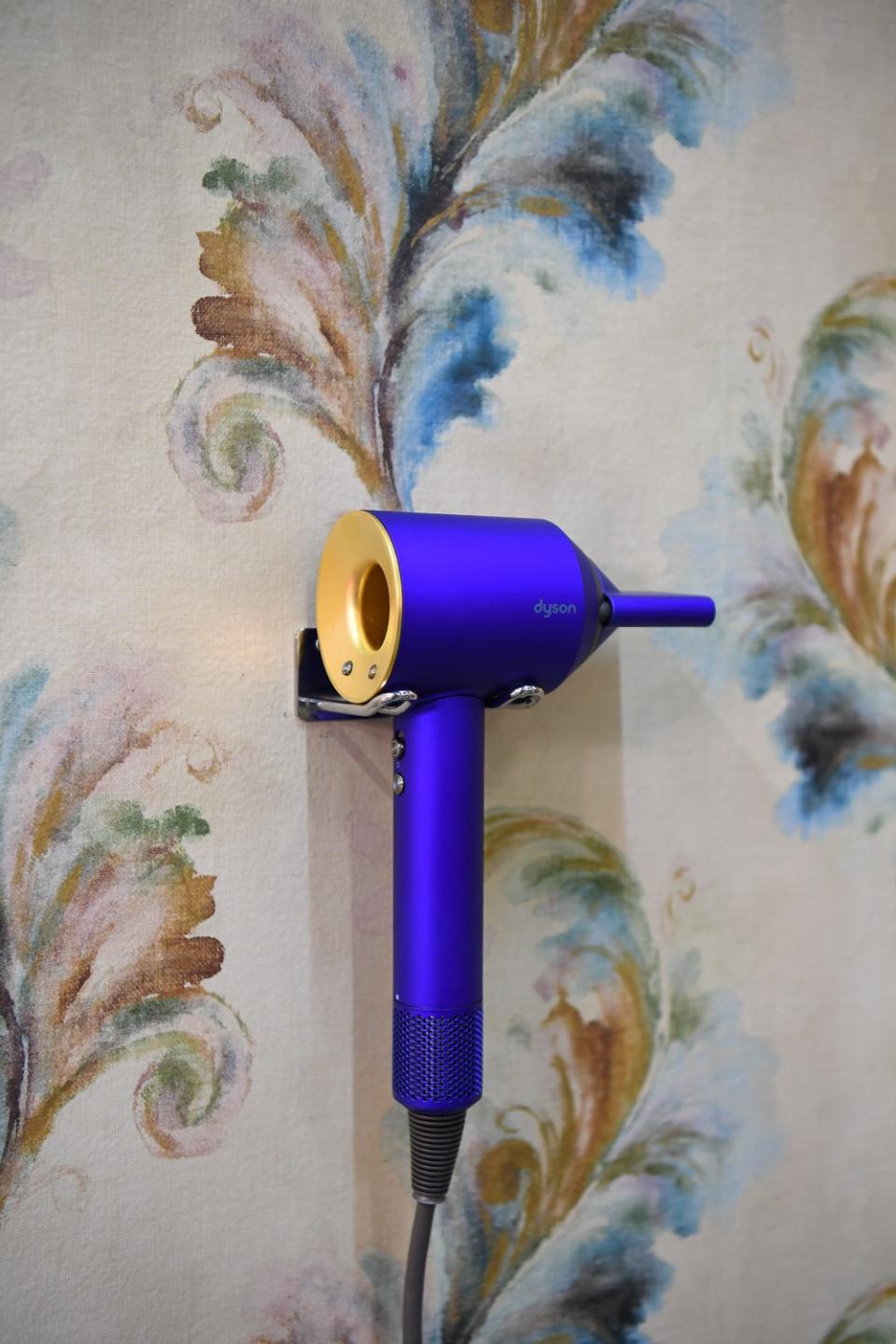 A Dyson Supersonic™ hair dryer in 23.75-karat gold.