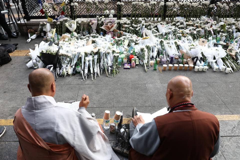 Monks pay tribute for the victims of the Halloween celebration stampede, on the street near the scene on 31 October 2022 in Seoul, South Korea (Getty Images)