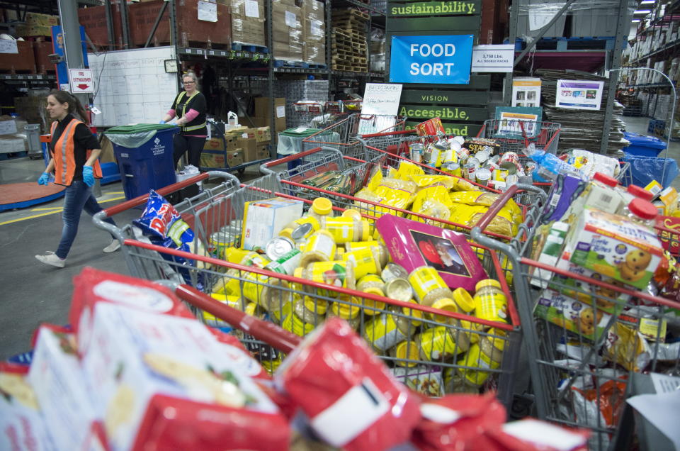 Staff at the Greater Vancouver Food Bank prepare food in Burnaby, British Columbia, Wednesday, March 18, 2020. (Jonathan Hayward/The Canadian Press via AP)