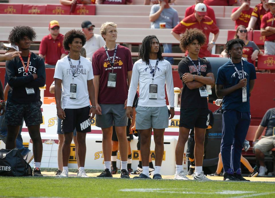 Iowa State recruits, from left: Jalyn Thompson of Dowling Catholic, Alex Mota of Marion, JJ Kohl of Ankeny, Jamison Patton of Des Moines Roosevelt, Kaidan Ivory of Waukee Northwest and Jaekwon Bradley of Des Moines Roosevelt watch the Cyclones warm up prior to kickoff against Iowa at Jack Trice Stadium in Ames on Saturday, Sept. 11, 2021.