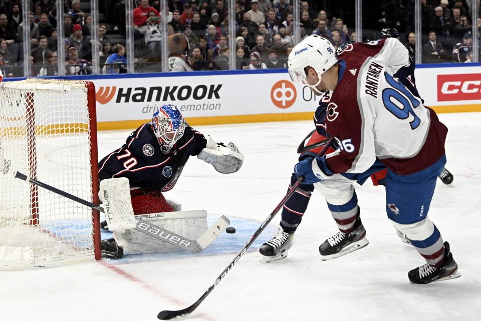 Columbus Blue Jackets goalkeeper Joonas Korpisalo saves against Mikko Rantanen, right, of Colorado Avalanche, during the 2022 NHL Global Series ice hockey match between Colorado Avalanche and Columbus Blue Jackets in Tampere, Finland, Saturday, Nov. 5, 2022. (Emmi Korhonen./Lehtikuva via AP)