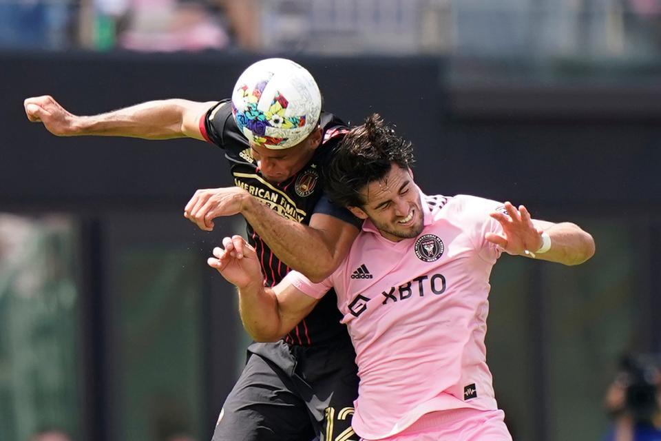 Atlanta United defender Miles Robinson, left, heads the ball against Inter Miami forward Leonardo Campana, Sunday, April 24, 2022, during the second half of an MLS soccer match in Fort Lauderdale, Fla. (AP Photo/Wilfredo Lee)