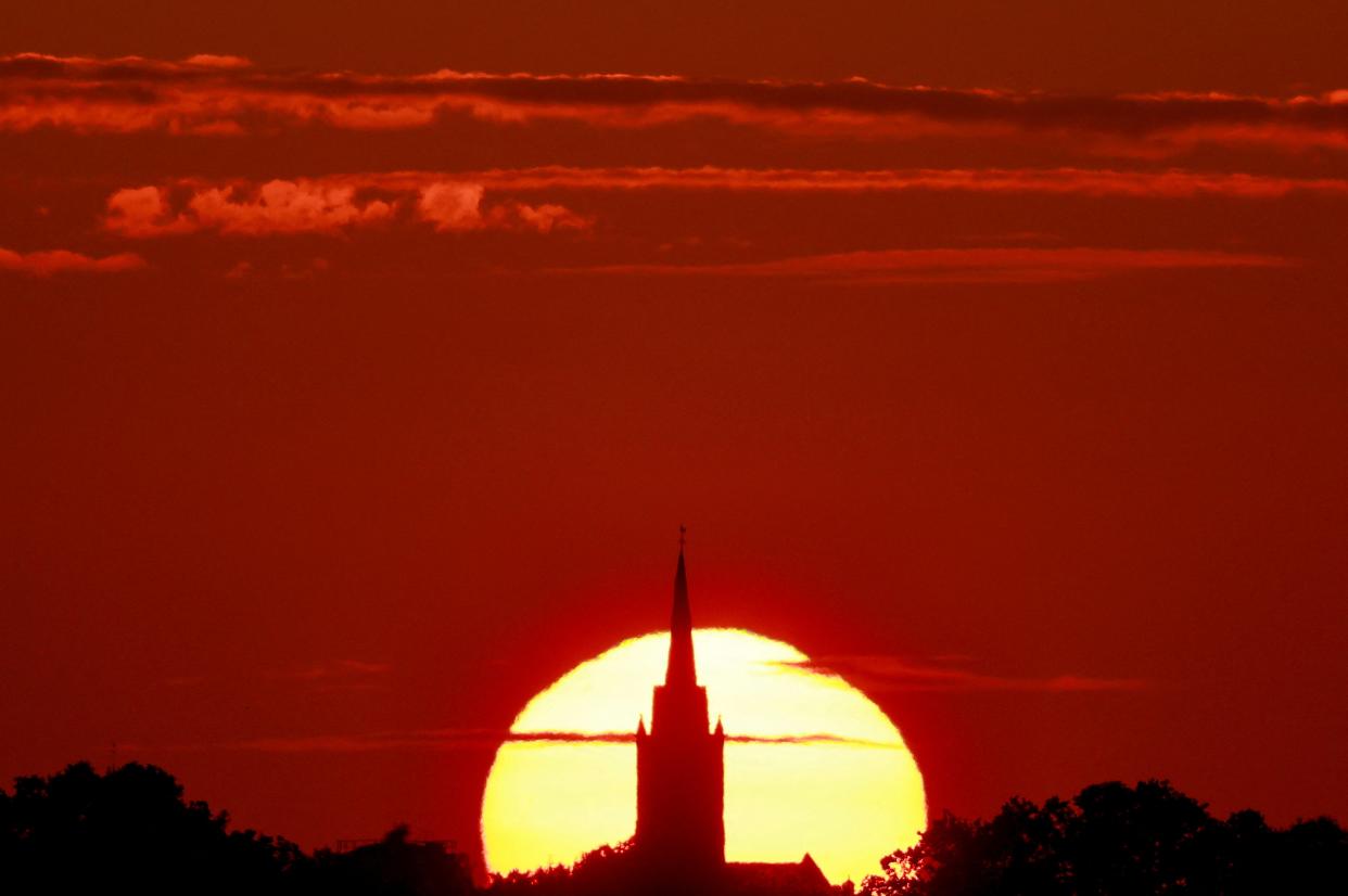 A church is pictured during sunset as a heat wave hits Europe, in Sancourt, France (REUTERS)