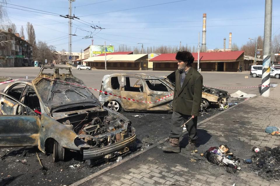 A man walks past burned cars at the site of a missile strike, at a rail station, amid Russia's invasion of Ukraine, in Kramatorsk (REUTERS)