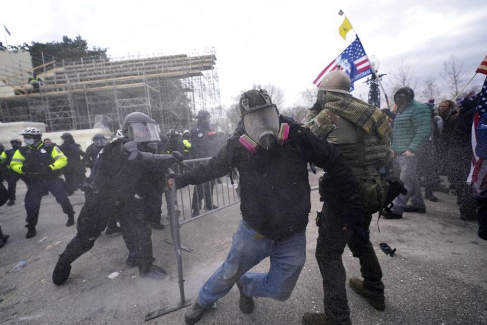 Trump supporters try to break through a police barrier, Wednesday, Jan. 6, 2021, at the Capitol in Washington. As Congress prepares to affirm President-elect Joe Biden's victory, thousands of people have gathered to show their support for President Donald Trump and his claims of election fraud. (AP Photo/Julio Cortez)