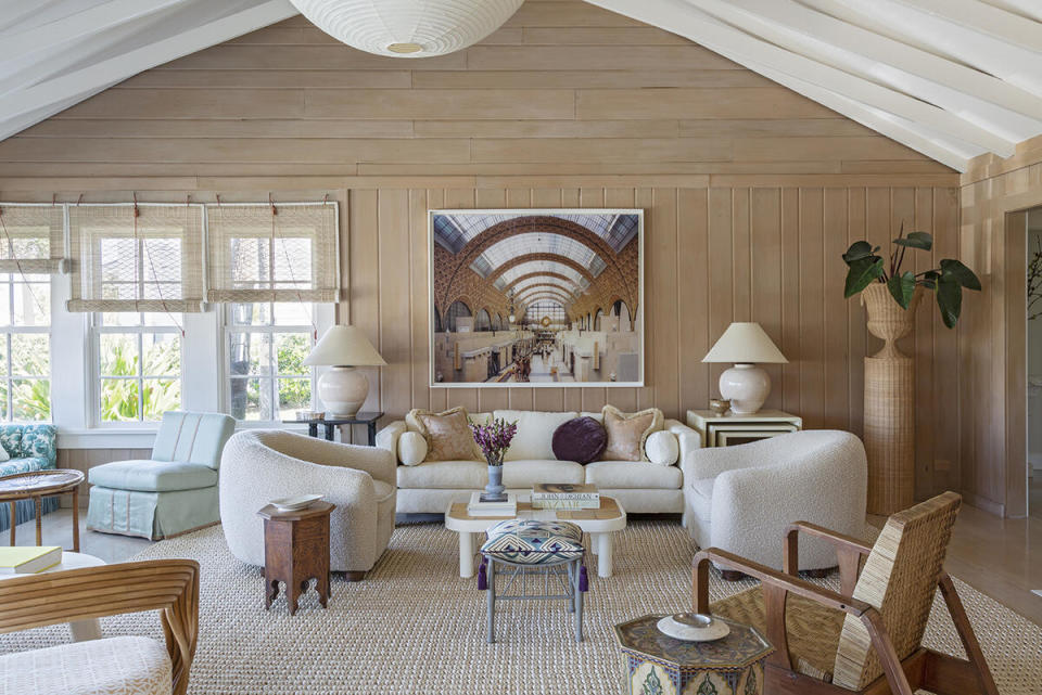 A Florida living room features several seating arrangements that all maximize the room’s expansive views