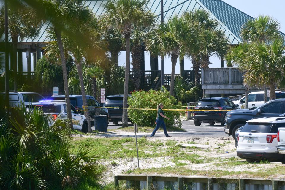 A portion of The Boardwalk on Okaloosa Island was cordoned off with crime scene tape Friday after Okaloosa County sheriff's deputies shot and killed a man who allegedly injured a tourist with a machete. i