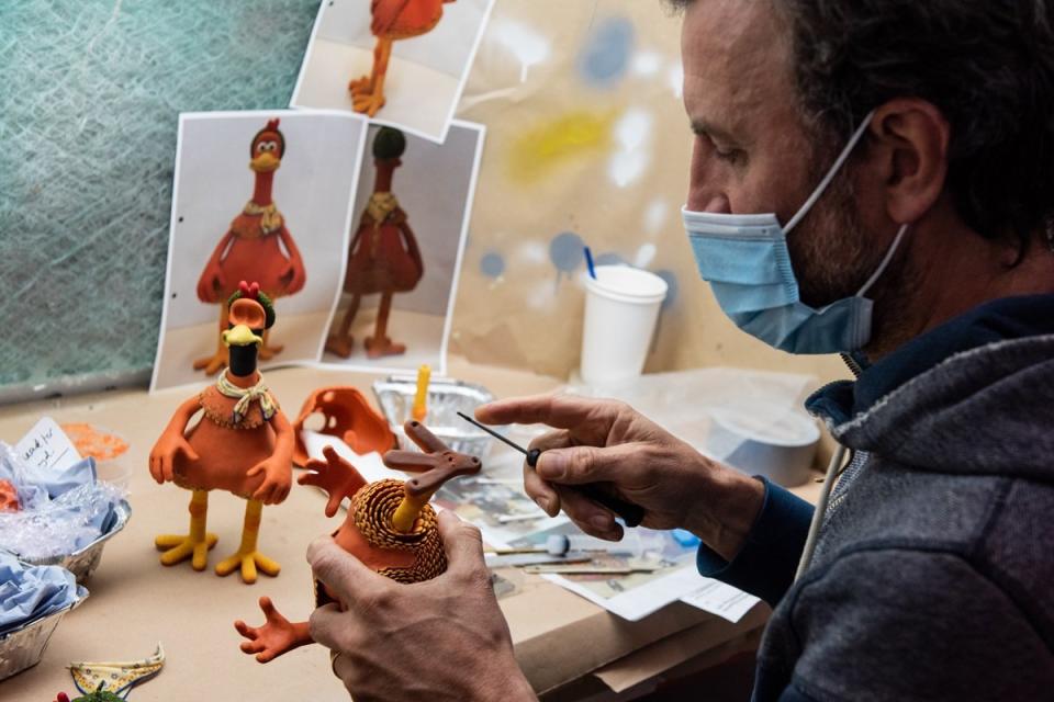 A puppet maker at Aardman Animations works on a model from Chicken Run: Dawn of the Nugget.