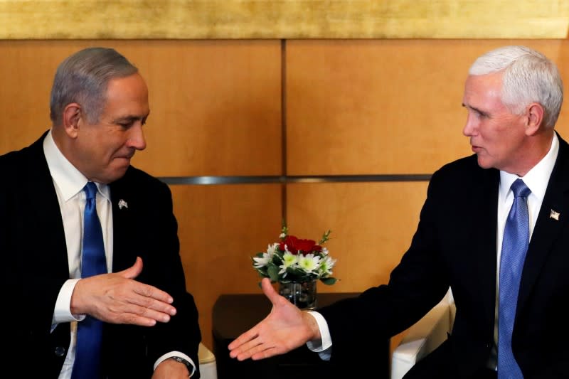 Israeli Prime Minister Benjamin Netanyahu and U.S Vice President Mike Pence prepare to shake hands during their meeting at the U.S embassy in Jerusalem