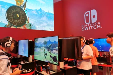 Visitors are seen at a booth of Nintendo Switch at the China Digital Entertainment Expo and Conference, also known as ChinaJoy, in Shanghai