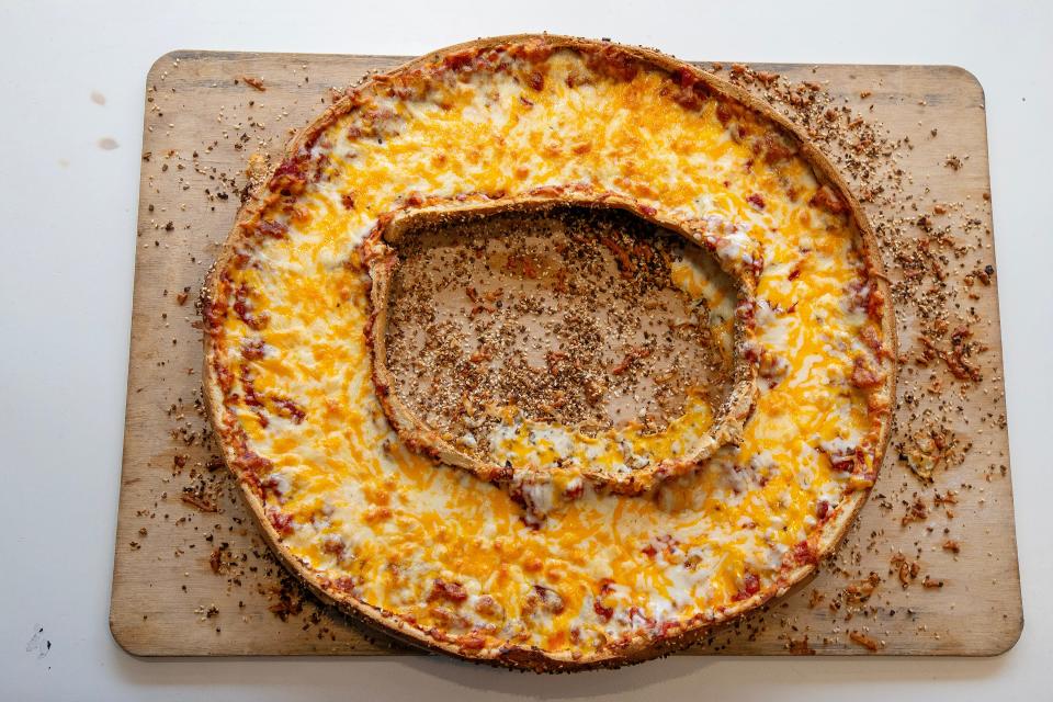 The giant pizza bagel at Hot Bagels in Lakewood is made from an everything bagel topped with tomato sauce and shredded cheddar and mozzarella cheeses.