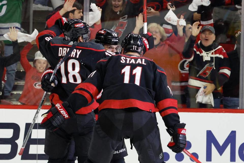 Carolina’s Jack Drury (18) and and Jordan Staal (11) celebrate with Jordan Martinook (48) after Martinook scored to put the Canes up 4-3 during the third period of the Hurricanes’ 5-3 victory over the Islanders in the first round of the Stanley Cup playoffs at PNC Arena in Raleigh, N.C., Monday, April 22, 2024.