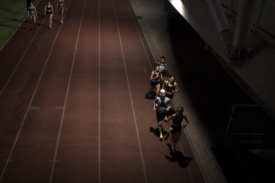 Beatie Deutsch, an Orthodox Jewish runner, second from bottom right, trains with her team in Tel Aviv, Israel, Wednesday, June 26, 2024. “Most people would see sports and religion as very separate, but I see a big overlap. Everything we have is a gift from God – He’s the one who’s given me this strength,” says Deutsch. (AP Photo/Maya Alleruzzo)