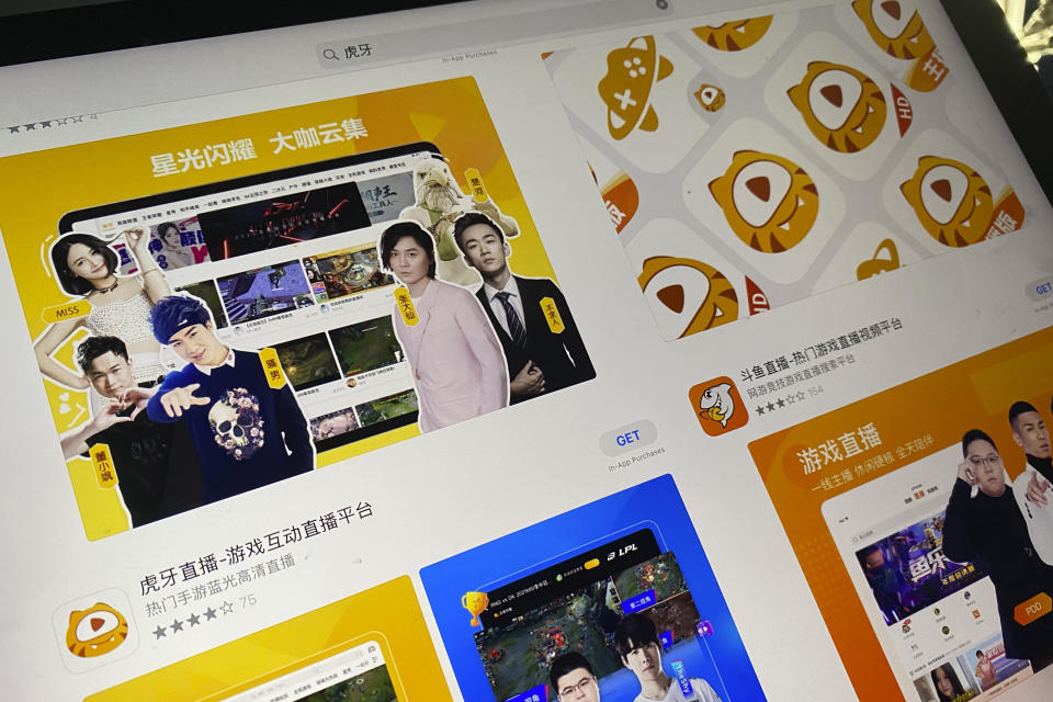 An app store page showing the apps Huya and Douyu is seen on a screen in Beijing on Saturday, July 10, 2021. China's market regulator on Saturday blocked the merger of Tencent-backed game streaming platforms Douyu and Huya following an anti-monopoly investigation, as authorities ramp up scrutiny of some of the country's biggest technology companies. (AP Photo/Ng Han Guan)