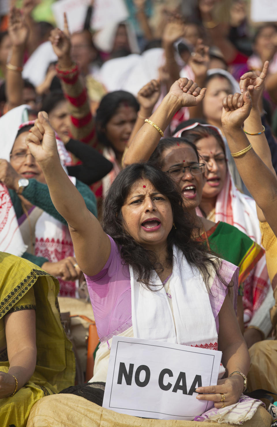 Indian women shout slogans during a protest against the Citizenship Amendment Act in Gauhati, India, Saturday, Dec. 21, 2019. Critics have slammed the law as a violation of India's secular constitution and have called it the latest effort by the Modi government to marginalize the country's 200 million Muslims. Modi has defended the law as a humanitarian gesture. (AP Photo/Anupam Nath)