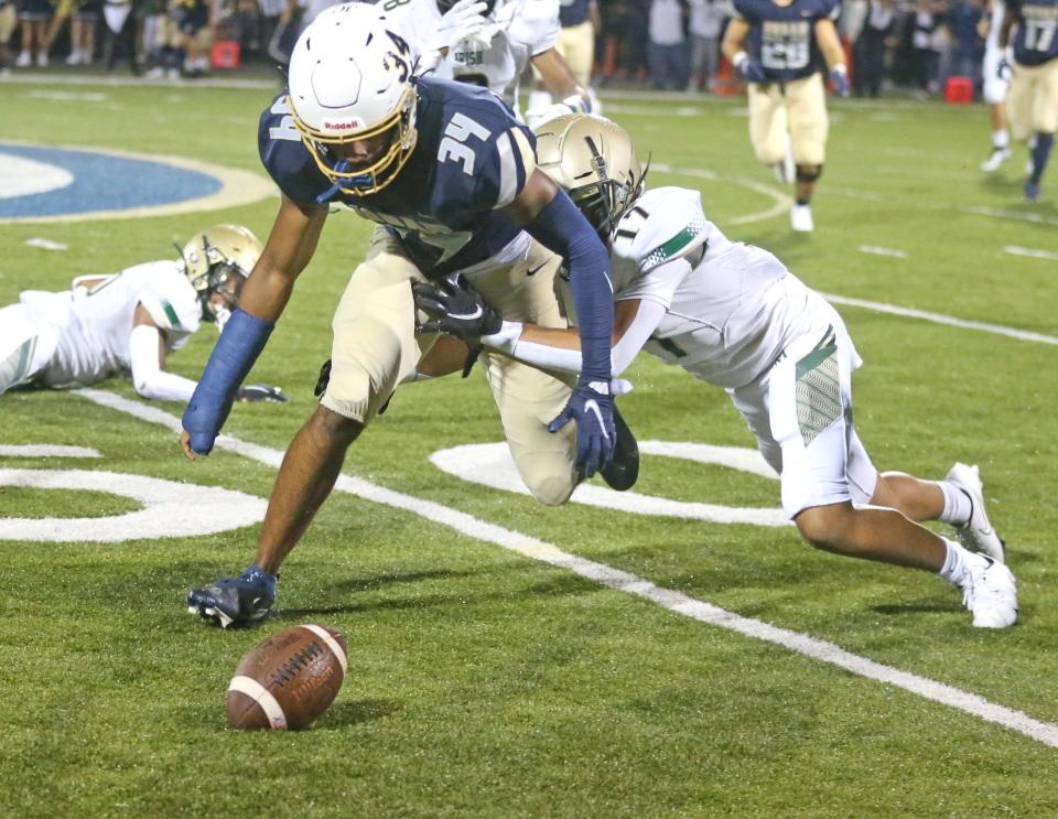 Archbishop Hoban senior Markim McKinnie recovers a fumbled punt by St. Vincent-St. Mary on Friday, Oct. 8, 2021 in Akron, Ohio, at Dowed Field. Hoban won the game. [Phil Masturzo/ Beacon Journal]