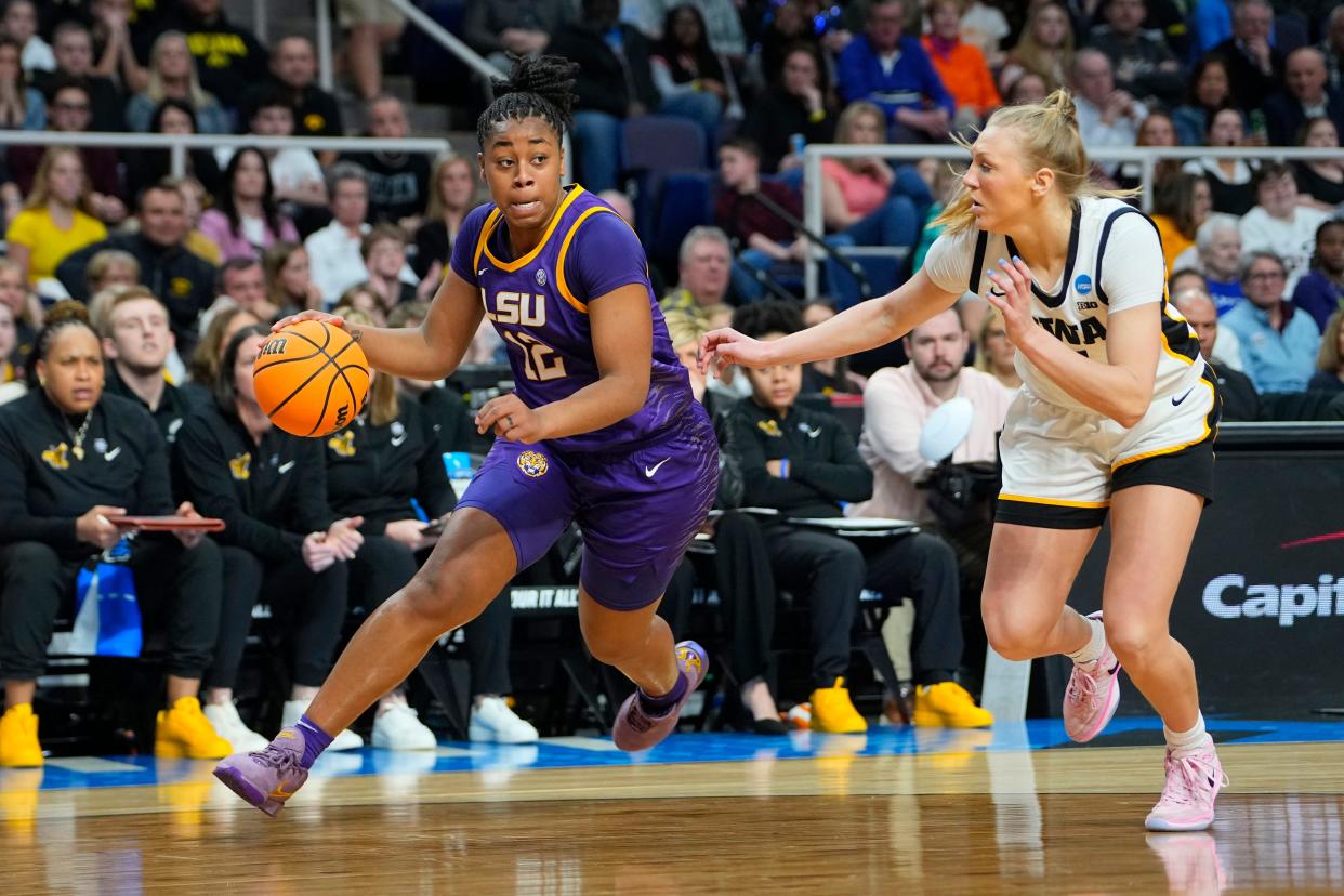 Apr 1, 2024; Albany, NY, USA; LSU Lady Tigers guard Mikaylah Williams (12) controls the ball against Iowa Hawkeyes guard Sydney Affolter (3) in the second quarter in the finals of the Albany Regional in the 2024 NCAA Tournament at MVP Arena. Mandatory Credit: Gregory Fisher-USA TODAY Sports