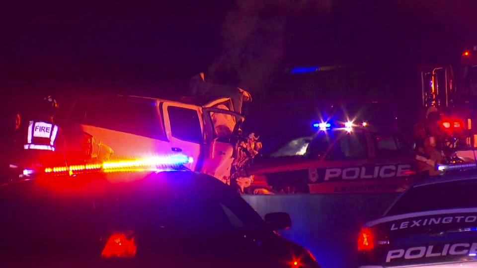 In this photo provided by LEX18, police officers and firefighters work at the scene of a deadly crash on Interstate 75 in Lexington, Ky., Sunday, Jan. 6, 2019. A suspected drunken driver heading the wrong way on a pickup truck struck a vehicle carrying several family members from Michigan early Sunday, killing all occupants of the vehicle, along with the pickup's driver, authorities said. (LEX18 via AP)