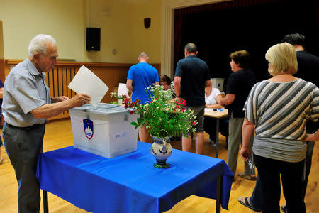 People vote at a polling station during the general election in Kamnik, Slovenia, June 3, 2018. REUTERS/Srdjan Zivulovic