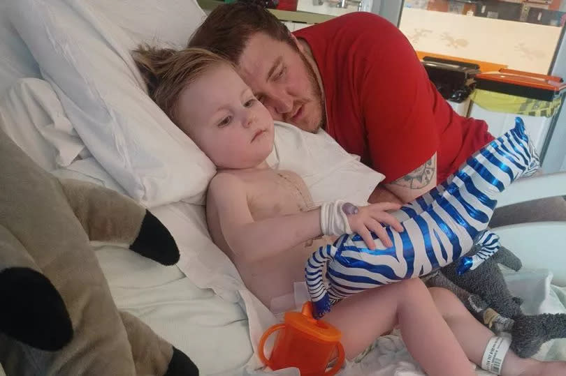 Enzo with his dad, Lee, in hospital