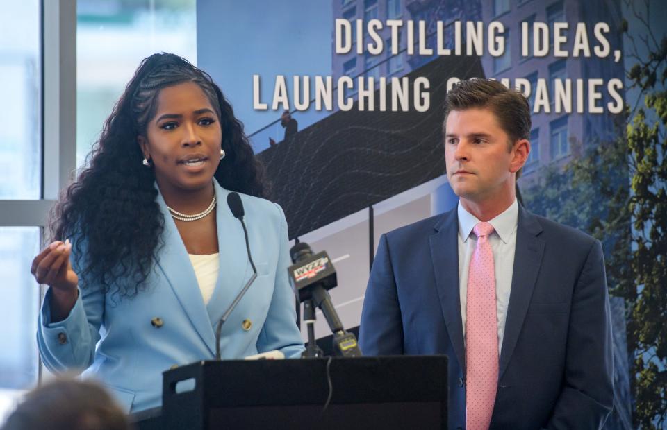 State Rep. Jehan Gordon-Booth, left, and State Rep. Ryan Spain take turns speaking to a crowd gathered for a ceremony Thursday, Aug. 17, 2023 at 201 SW Adams Street, the future site of the new Distillery Labs innovation center in downtown Peoria.