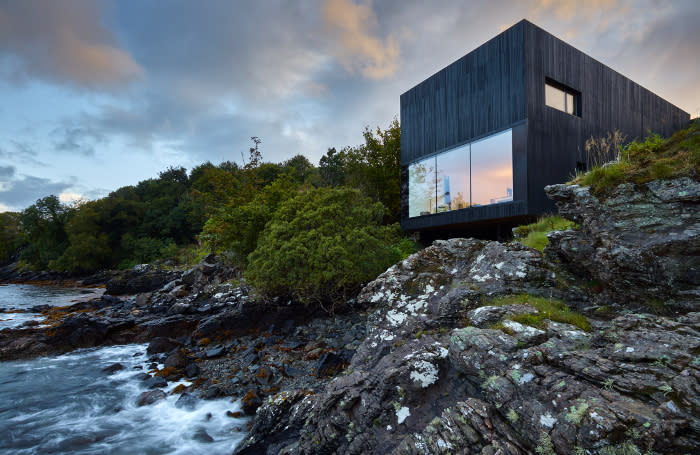 This black-timbered house on the Isle of Skye was built right next to the water's edge with the aim of showing its connection to the sea (Picture: Andrew Lee)