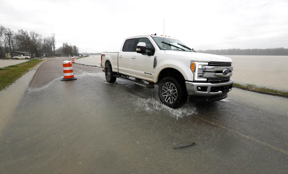 In this Monday, March 11, 2019 photo, backflow waters flood a section of Mississippi 16 near Rolling Fork, Miss. In March 2019, scientists are warning that historic flooding could soon deluge parts of several southern states along the lower Mississippi River, where flood waters could persist for several weeks. (AP Photo/Rogelio V. Solis)